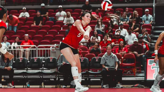 Elia Dinsmore digging out a ball for Texas Tech volleyball against Kansas