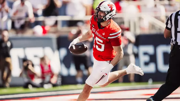Austin Romaine celebrates after entering the end zone following his pick-six interception in Texas Tech's win over Sam Houston.