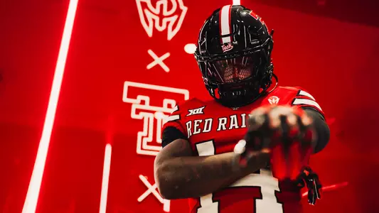 Brice Pollock shows off Texas Tech's black-red-black uniform combination that the Red Raiders will wear against Abilene Christian.