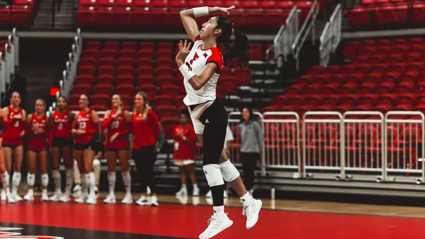 Emily Contreras serving the ball for the Red Raiders against Kansas