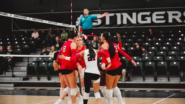Red Raider volleyball players huddled up after a point against Nevada