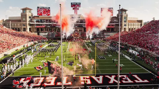 The Red Raiders make their entrance into Galaxy Stadium as red smoke fills the air for the sellout crowd.