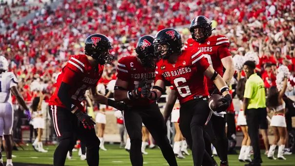 John Curry celebrates with his teammates after intercepting the first play of the second half in Texas Tech's win over Abilene Christian.