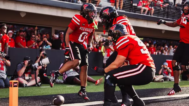 Quinten Joyner celebrates with teammates after scoring a touchdown on his first carry in Texas Tech's victory over Abilene Christian.