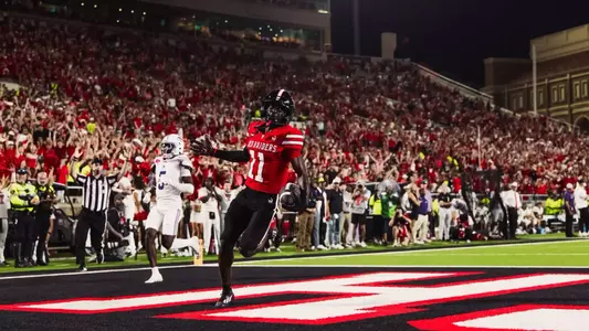 Malcolm Simmons celebrates after crossing the goal line following his first career catch and touchdown as a Red Raider against Abilene Christian.
