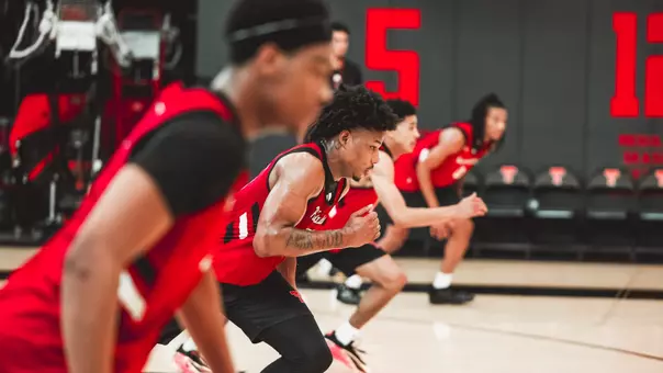 Jamichael Stillwell races down the court during a conditioning drill in an out of season practice.