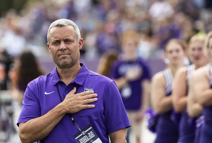 Athletic Director Phil Esten stands at attention during the national anthem during the Homecoming Football game against Valparaiso University in St. Paul on October 9, 2021.