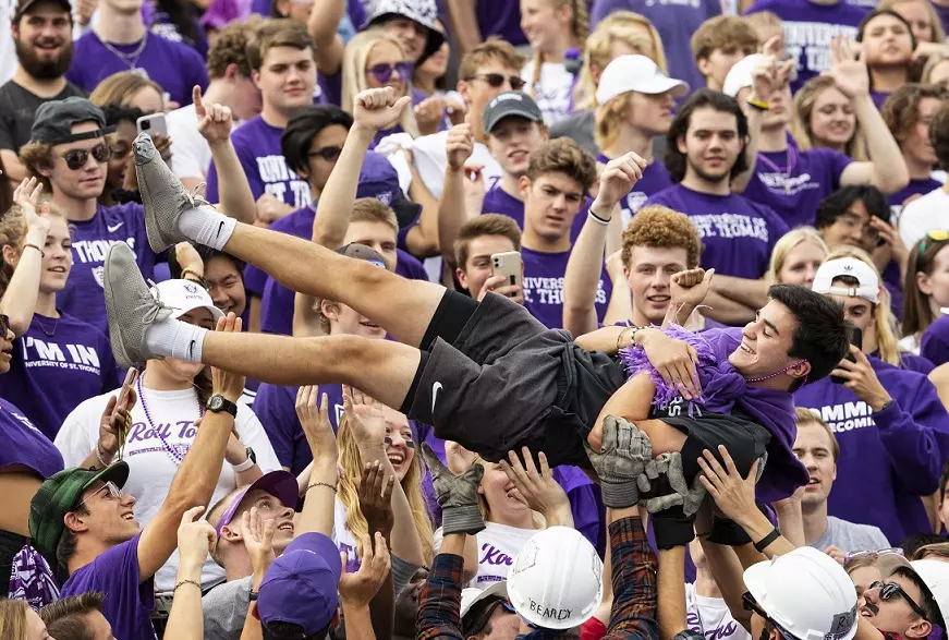 Carusoâ??s Crew tosses a fan in the air during the Homecoming Football game against Valparaiso University in St. Paul on October 9, 2021.