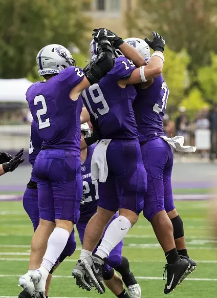 The defense celebrates during the Homecoming Football game against Valparaiso University in St. Paul on October 9, 2021.