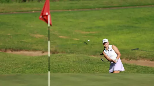 Kathryn VanArragon chips from the bunker onto the green.