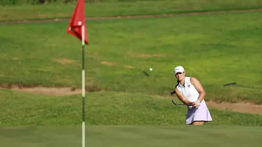 Kathryn VanArragon chips from the bunker onto the green.