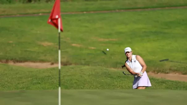 Kathryn VanArragon chips from the bunker onto the green.