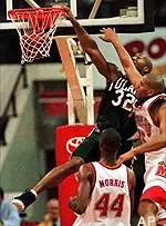 Sterling Davis dunks over Maryland's Lonny Baxter, right, and Terence Morris in the first half.