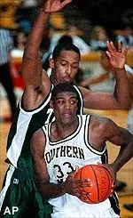Southern Mississippi center Carlos Booker grabs an offensive rebound while Tulane center Morris Jordan covers him from behind on Saturday.