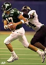 Tulane quarterback J.P. Losman rolls out to pass during first half action against Southern Mississippi.