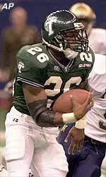 Tulane running back Mewelde Moore runs past Navy free safety Matt Brooks for 27 yards.