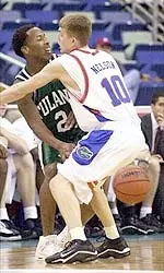 Tulane guard Brandon Spann (2) passes the ball around Florida guard Brett Nelson (10) during the first half.