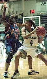 Tulane's Grace Daley tries to find a way around DePaul's Jamie Lewis during the first half of Tulane's 86-76 win. Daley went on to score 16 points.