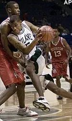 Tulane forward Trello Galloway charges through Houston's Kenny Younger in a Conference USA tournament game in Memphis Thursday.