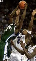 Tulane's Brandon Brown goes to the basket over Memphis' Chris Massie (4) and Anthony Rice (23) during the second half Monday.