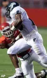 Mewelde Moore pushes his way past a Houston defensive back during the first half.