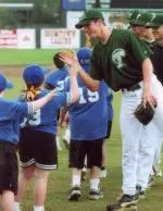 Tommy Manzella high-fives students at St. Michael's Elementary after last year's benefit.