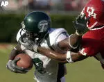 Wide receiver Roydell Williams tries to fend off Houston defender Stanford Routt during the first half.