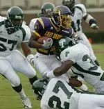 East Carolina's Chris Johnson, center, tries to get away from Tulane defenders, including Antonio Harris (57), Joey Dawson (27), Darren Sapp, right, during the second quarter Saturday, Oct. 9, 2004, in Greenville, N.C. East Carolina won 27-25. (AP Photo/East Carolina University, Marc J. Kawanishi)