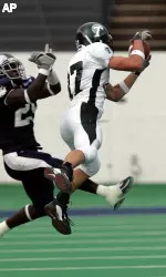 Tulane wide receiver Cary Koch makes the reception in front of Rice defender Andrew Cates during the second quarter. (AP Photo/Pat Sullivan)