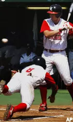 Louisiana-Lafayette's John Coker dives for the plate in an attempt to steal home as Southern's catcher Brandon Mason waits for the pitch in the second inning. Coker was safe at home.