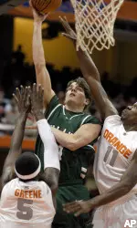 Daniel Puckett scores against Syracuse's Donte Greene and Paul Harris. (AP Photo/Kevin Rivoli)