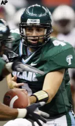 Junior quarterback Scott Elliott and the Green Wave battle the elements on Tuesday as rain and severe lightning foced the team inside for nearly half of the team's two-hour practice.