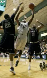 Tulane forward David Booker (2) shoots over Georgetown forward Julian Vaughn (22) and center Greg Monroe (10) during the first half of their NCAA college basketball game at Fogleman Arena in New Orleans, Friday, Nov. 13, 2009. (AP Photo/Sean Gardner)