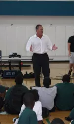 Riki Ellison, former 49er great and founder of the Youth Impact Program, addresses the Tulane campers during closing ceremonies.