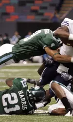 Tulane defensive backs Alex Wacha, Charles Harris and Chinonso Echebelem tackle BYU wide receiver O'Neill Chambers during the first half.