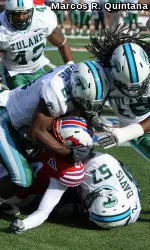 The Tulane defense converges on an SMU ballcarrier during the Green Wave's contest against the Mustangs on Saturday in Dallas.