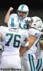 Senior kicker Cairo Santos celebrates with his teammates after nailing a 27-yard field goal as time expired to left Tulane to a 24-21 homecoming win over North Texas.