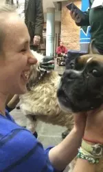Tulane's Emma Newton gets face-to-face with a dog from The Visiting Pet Program