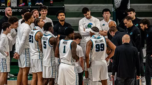 Tulane men's basketball in a team huddle during the Green Wave's game against Rice.