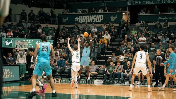 Scotty Middleton shoots a three-pointer on the road against South Florida.