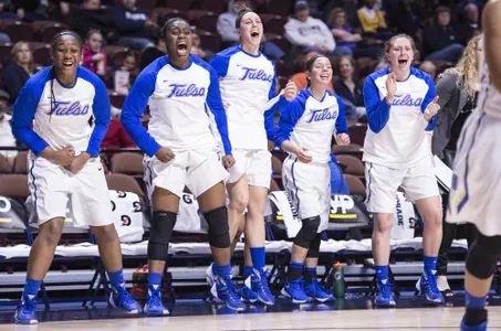women's basketball team bench celebrating
