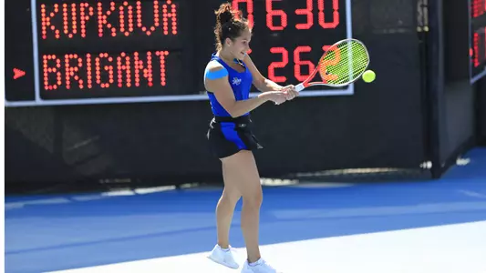 women's tennis player hitting the ball