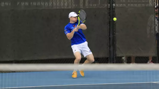 men's tennis player hitting the ball