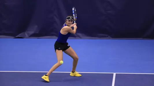 women's tennis player hitting the ball