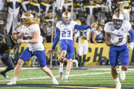 Thomas Bennett punting the football