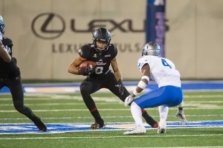 Tulsa's wide receiver Keenen Johnson (left) looks for a way past Memphis' defensive back Josh Perry during the game at H.A. Chapman Stadium in Tulsa, OK on 11/3/17.  BRETT ROJO/For the Tulsa World