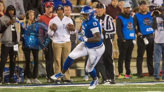 Denzel Carter looks for yardage