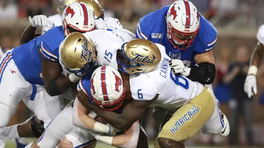 Tulsa defenders bring down a SMU ball carrier