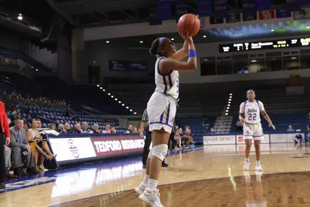 Desiree Lewis playing basketball