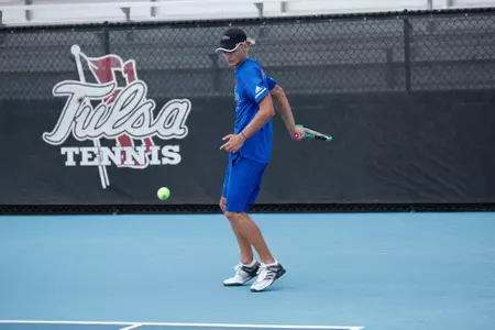 men's tennis player swinging a racket